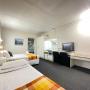Twin Share Room with en-suite bathroom. Air conditioning & heating service. A comfort large double bed and a single bed configuration with an e-blanket. Wide luggage storage, LED television, coffee maker, toaster, hair dryer & microwave provided. In room wireless connection with free parking on site. Housekeeping service available. (On request only)