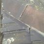 Ridge caps loose from old pointing falling away