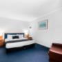 Guest room with king bed and 3 single beds