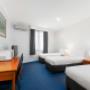Guest room with king bed and 3 single beds
