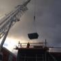 Crane lowering a skip