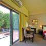 Guest room with queen bed and outdoor patio