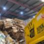 Goodbye-junk-yellow-truck-in-a-warehouse-full-of-cardboard-rubbish