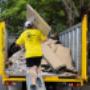 A Goodbye Junk Worker walking up to the Goodbye Junk trucks