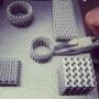 These parts are straight from our 3D printer, still attached to the build plate where our operator will remove the pieces from the supports. Chain mail pictured, designed and printed for bracelets and made entirely out of titanium are extremely light weight but extremely strong and virtually unbreakable. The rings will be polished up for a shiny finish.
