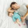 Dad and baby on bamboo sheets