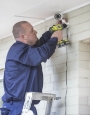 Technician Installing a security system