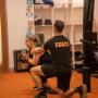 Helping a member with their squats.