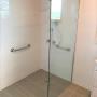 Bathroom renovation with disabled fittings and frameless shower.