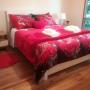 The Queen Room has a walk-in robe/dressing room, access to the toilet and a balcony overlooking the garden. Quality linen and towels are provided. Bed linen is professionally laundered offsite.