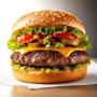 Beef burger served at Coffee & Dreams in Adelaide CBD, made with an Angus patty, cheese, onion, tangy sauce, and fresh burger toppings.