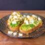 Smashed avocado at Coffee & Dreams in Adelaide CBD, served on an English muffin with poached eggs, spinach, feta, and hollandaise sauce.