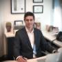 Dr Rodrigo Teixeira in his consulting room finishing plans for facial cosmetic treatment.