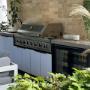 Outdoor BBQ kitchen featuring a double door bar fridge