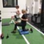 Youth athletes Marcus and Jess performing 1/2 kneel cable rows to develop their back muscles to help improve their sporting performance.
