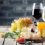 Wine and cheese on wooden table