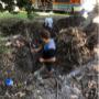 Plumber digging up sewer drains