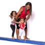 Coach helping gymnast on balance beam