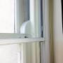Close up vertical slider scondary glazing over existing vertical sliding window