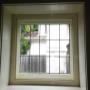 Fixed secondary glazing over feature window