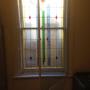 Hinged scondary window over vertical slider window