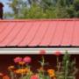 red-metal-roof-complimented-by-flowers