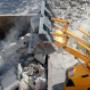 Bulldozer loader uploading concrete debris into dump truck