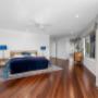 Spacious upstairs room with timber floors, balcony doors, and telescope