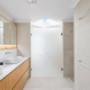 Walk-in wardrobe with custom shelving, hanging rails, and centre island drawers