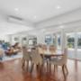 Open-plan dining area with marina views and large sliding glass doors