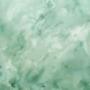 A Venetian plaster wall in a light seafoam green colour with a glossy finish