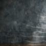 A dark slate gray Venetian plaster wall with a high-gloss finish