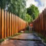 A wooden fence being painted