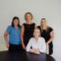 A group photo of four Trekk Gympie team members, gathered around a table and smiling at the camera. This welcoming portrait showcases the local team’s professionalism, warmth, and unity.