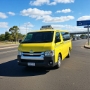 A maxi taxi at a residential area in Chermside with the Brisbane Airport in the background One real