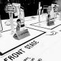 Service design workshop table with paper cutouts showing customer journeys and needs. Speech bubbles highlight goals like "Maximise my ability to make informed choices," mapped on a labeled "Front Stage" layout for service touch-points.