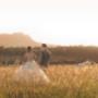 bimbadgen Hunter Valley Bride and Groom having there picture taken in the long grass with princess car in the background shot taken by Thierry Boudan Photography