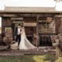 wedding Bride and Groom kissing on porch of old rustic building in the Hunter Valley photographed by Thierry Boudan Photography