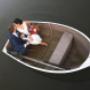 Bride and Groom kissing in a boat from a Ariel view in a pond from Hunter Valley venue by Thierry Boudan Photography