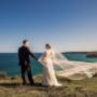 wedding couple on scenic hill in Newcastle having there photo taken venue merewether surf house photographed by Thierry Boudan Photography