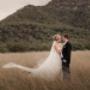 margan wine venue in the Hunter Valley a Bride and Groom kissing in the long grass by Thierry Boudan Photography