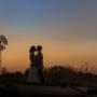 beautiful Bride and Groom pose in front of the pond during sunset at Adams peak country estate broke by Thierry Boudan Photography