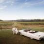 Bride and Groom walking in the scenic vines of Wyndham estate Hunter Valley by Thierry Boudan Photography