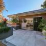 Landscaped courtyard with sliding doors opening to a modern garden room