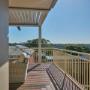 Covered deck with pergola roof, wicker lounge and valley views at Hawthorne home