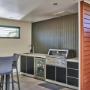 Built-in alfresco kitchen with sink, bar fridge and stainless barbecue