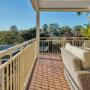 Elevated covered balcony with cream railing and wicker seating