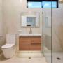 Main bathroom with floating timber vanity, brass tapware, and walk-in shower