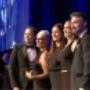 Trish Hammond getting photo taken with team after accepting award in 2015 for best beauty blogger