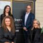 The Trekk Advisory Northern Rivers team standing proudly in front of their office signage. The group of professional business advisors and accountants exudes a welcoming and trustworthy presence, ready to support local businesses.